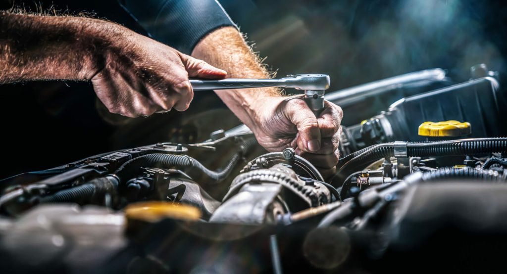 Image of a mechanic fixing a car