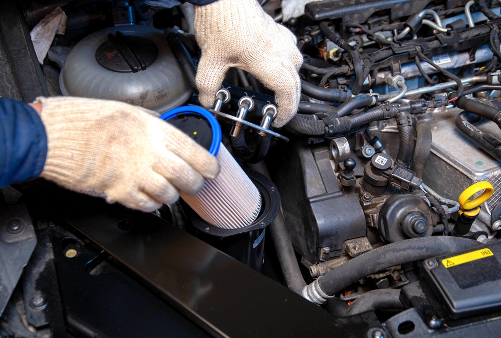 Image of a mechanic changing fuel filter