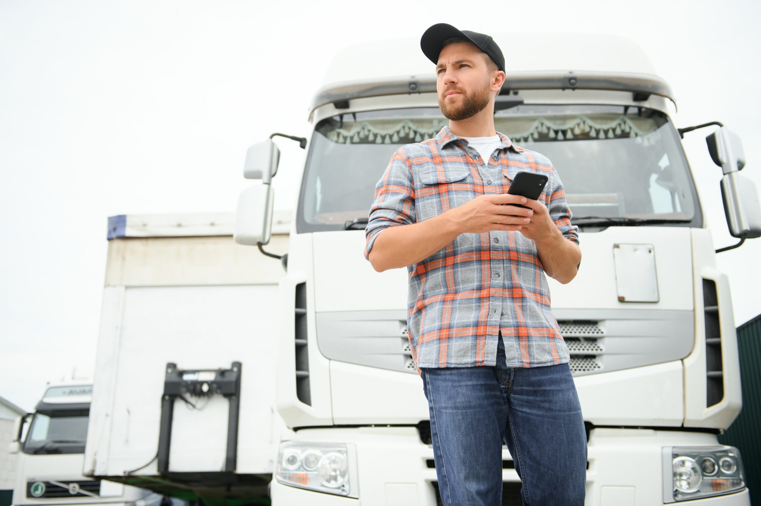 Portrait,Of,Confident,Truck,Driver,On,Parking,Lot,Looking,At
